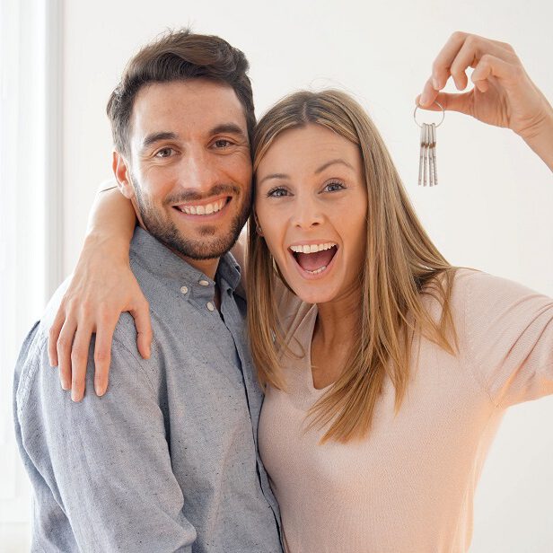 Couple with keys to rental apartment in Munich